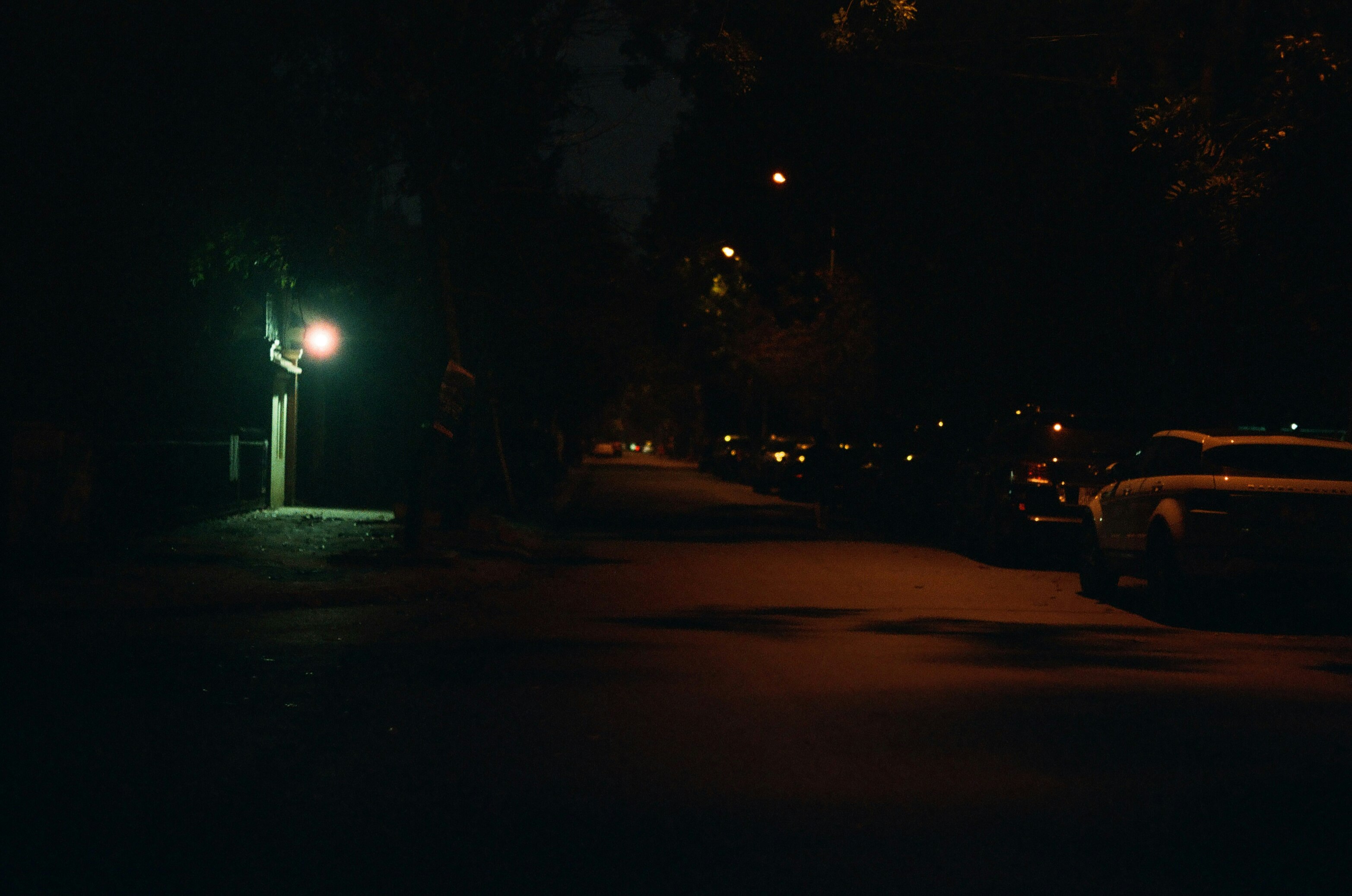 person standing on road during night time